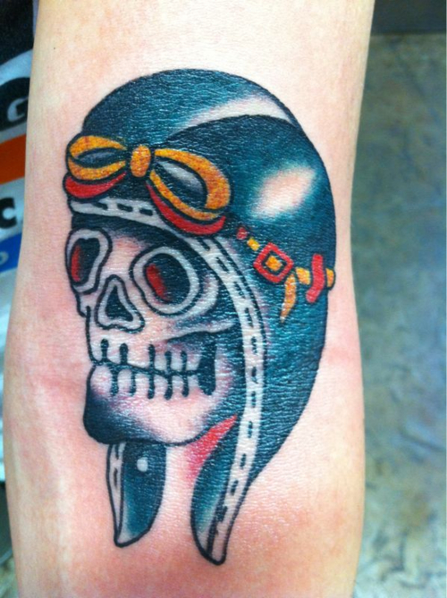 Traditional skull tattoo with pilot helmet on arm