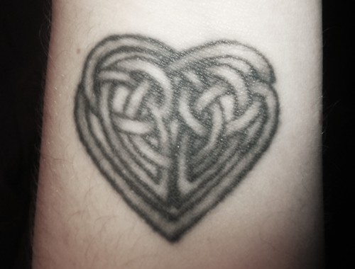 Small black celtic heart tattoo on wrist