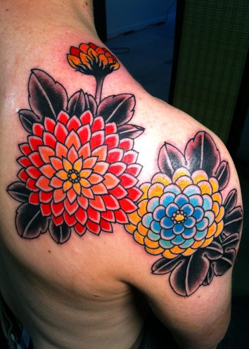 Mens colorful zinnia flower tattoo on shoulder