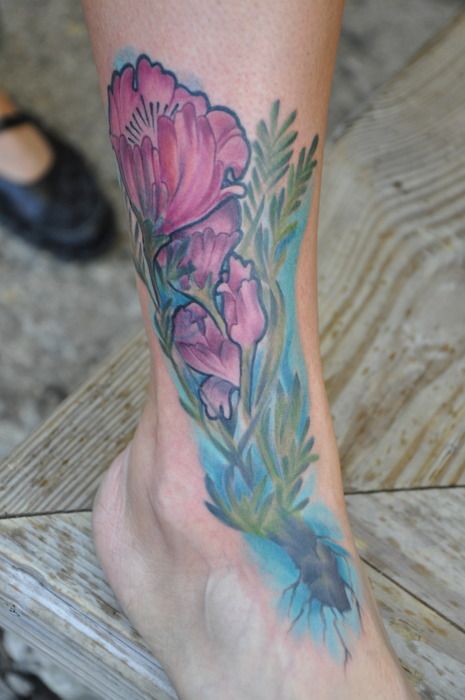 Flower and peace sign foot tattoo