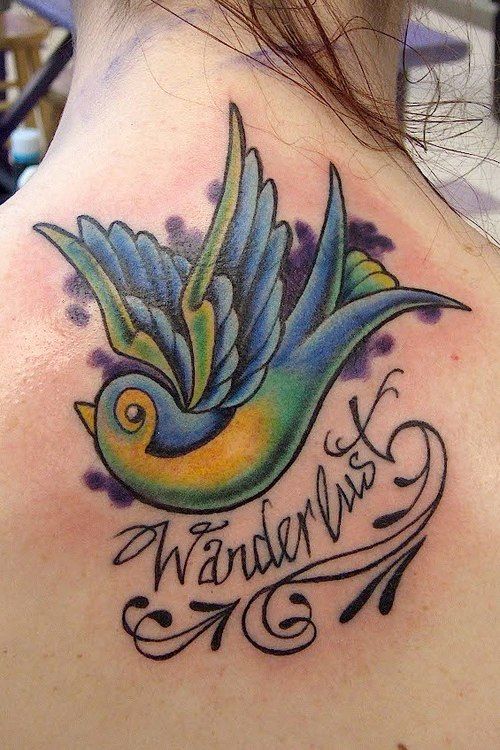 Wanderlust colorful swallow tattoo on back of girl’s neck
