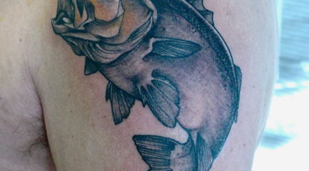 Bass fish tattoo on guys upper arm