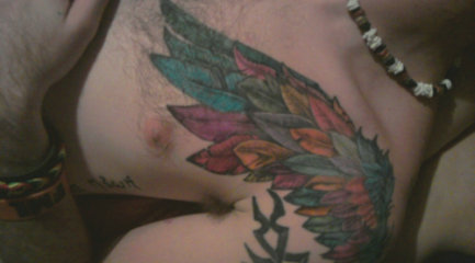 Colorful angel wing feathers on guys chest and shoulder