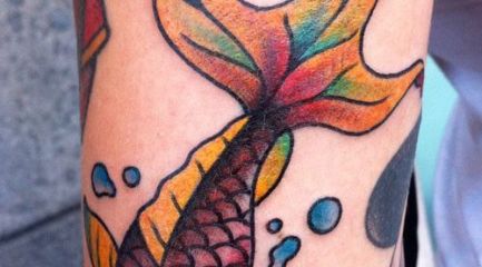 Colorful goldfish tattoo w water drops