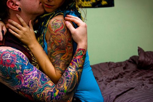 Couples colorful sleeve tattoos