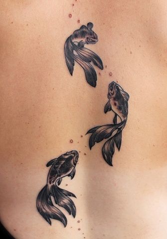 Cute black goldfish tattoos on girls back