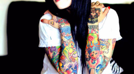 Girls colorful sleeve tattoos w. a little of everything