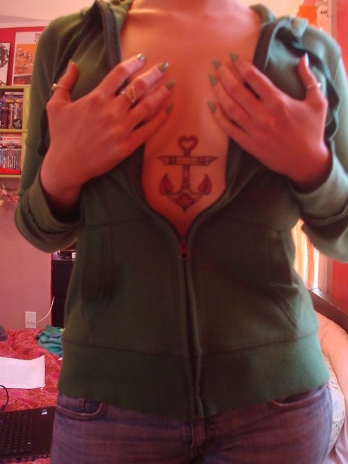 Girls traditional chest anchor tattoo with heart