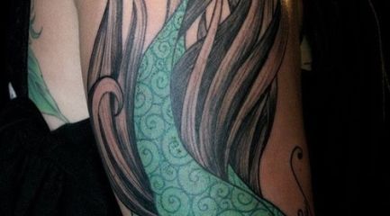 Girly female fish arm tattoo