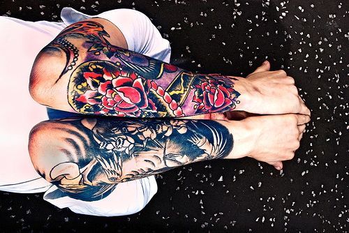 One black and white and one colored sleeve tattoos