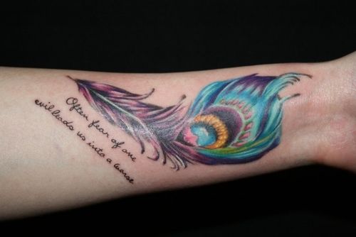 Peacock feather tattoo with quote on arm
