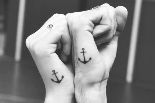 Simple black anchor tattoos on hands