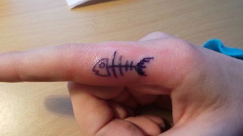 Simple fish skeleton finger tattoo