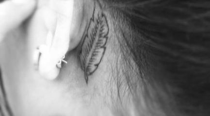 Small feather outline behind girls ear