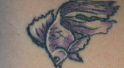 Small purple and black goldfish tattoo