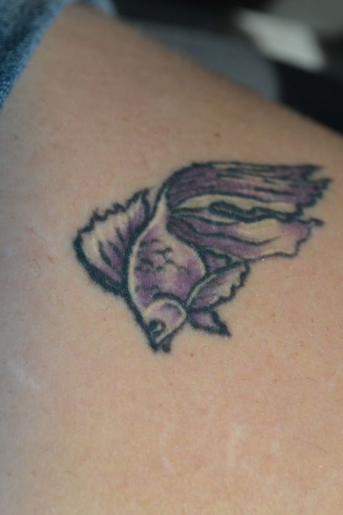 Small purple and black goldfish tattoo