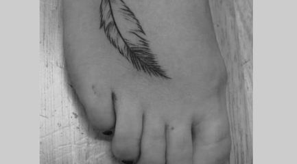Small simple feather tattoo outline on girls foot