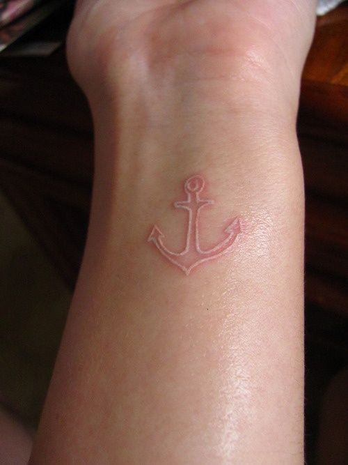 Small white ink anchor tattoo on wrist