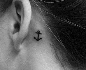 Tiny black cute anchor tattoo behind ear