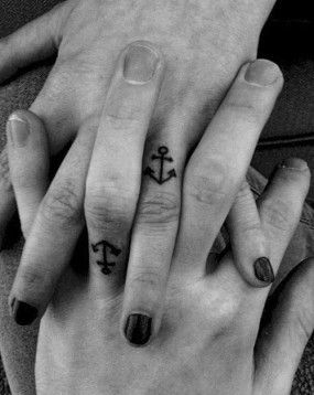Tiny black finger anchor tattoos