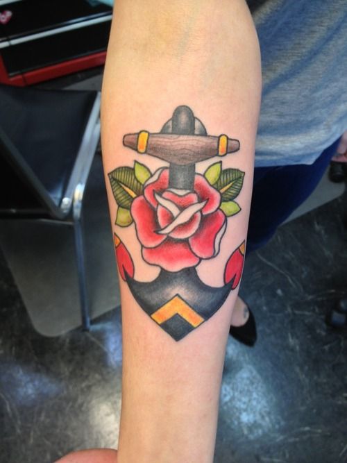 Traditional anchor and rose tattoo on forearm