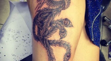 Black and white phoenix leg tattoo with long feathers