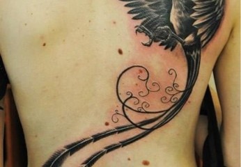 Black flying phoenix tattoo with long tail feathers