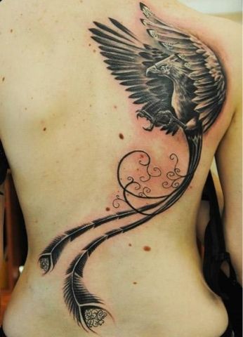 Black flying phoenix tattoo with long tail feathers