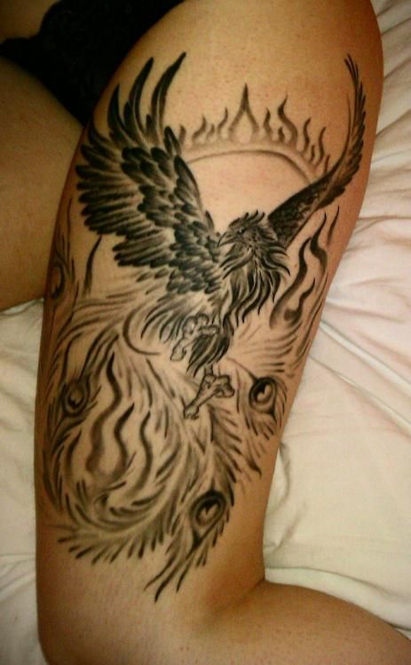 Black phoenix and sun tattoo on girls leg