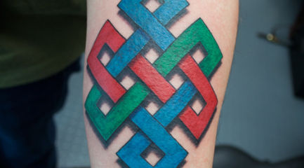 Colorful geometric Celtic knot arm tattoo
