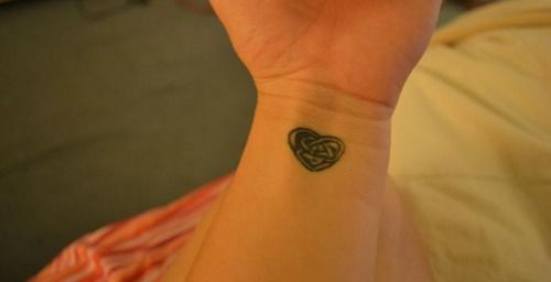 Cute Celtic knot and heart tattoo on girls wrist