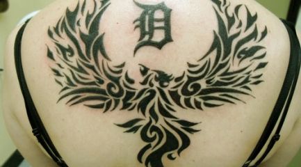 Girls huge tribal phoenix tattoo on her back