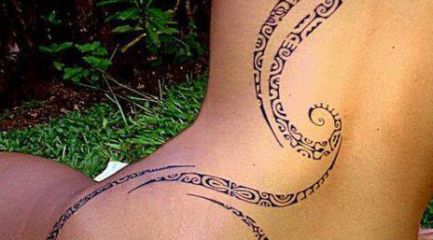 Girls long Polynesian back tattoo