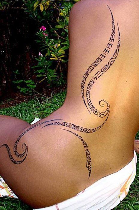 Girls long Polynesian back tattoo
