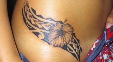 Girls Polynesian hibiscus tattoo on her hip