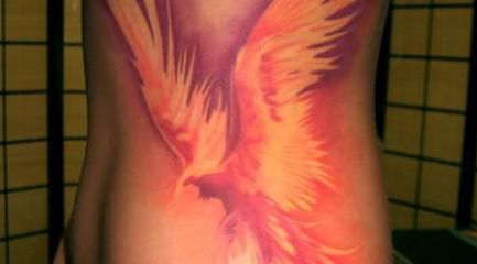 Girls side Phoenix on fire tattoo