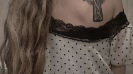 Girls tribal Celtic cross tattoo on her shoulder