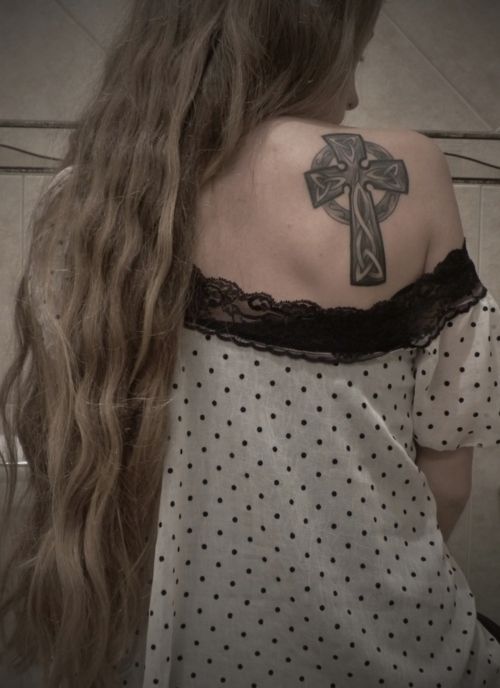 Girls tribal Celtic cross tattoo on her shoulder