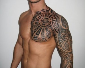 Guys chest and sleeve Polynesian tattoo with sun