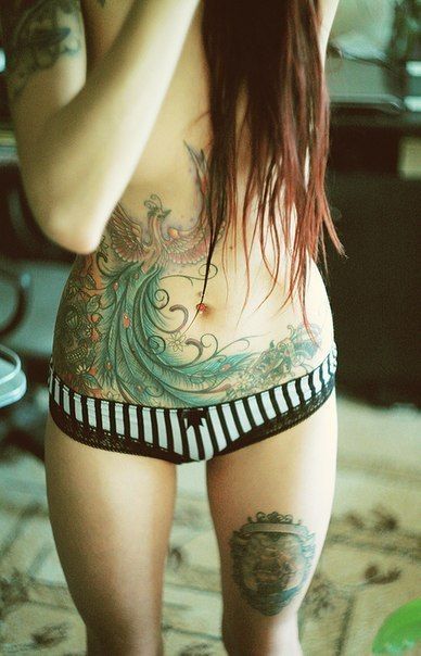 Intricate phoenix tattoo on girls stomach and waist