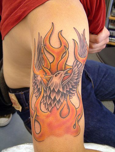 Phoenix rising out of fire tattoo on guys arm