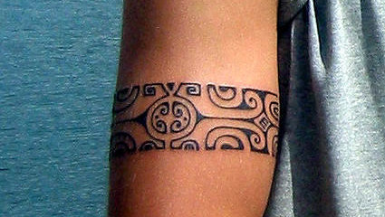 Polynesian armband tattoo on guys bicep
