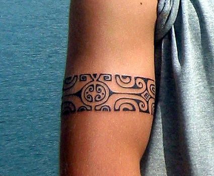 Polynesian armband tattoo on guys bicep
