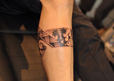 Polynesian leg band tattoo with palm trees