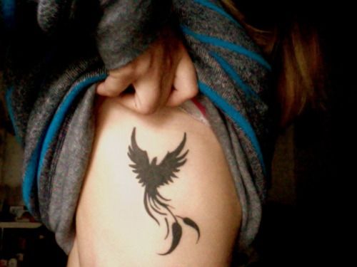 Simple black phoenix tattoo on ribcage
