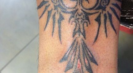 Small wrist tribal phoenix tattoo